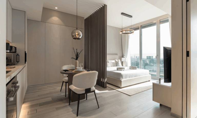 Flexible apartment layout in Dubai featuring fold-away desk, modular sofa, and open-plan design